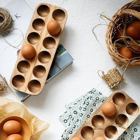 Wooden egg trays styled with eggs and a wire basket