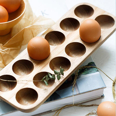 Twelve-hole wooden egg tray filled with eggs