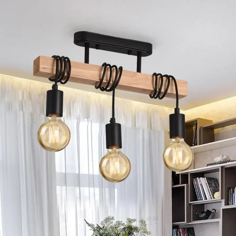 Three-bulb wooden bar pendant light in a room with curtains