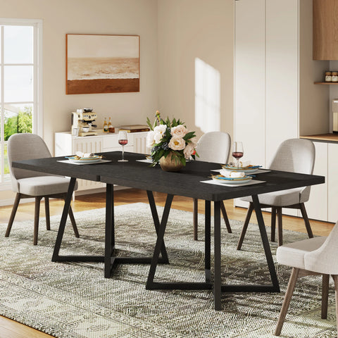 Black dining table with cream chairs in a bright room