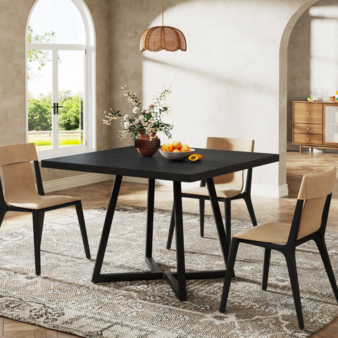 Black dining table with black crossed legs and dining chairs
