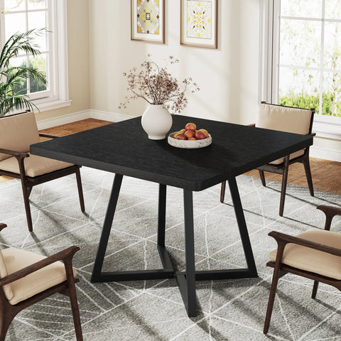 Black dining table with black crossed metal legs