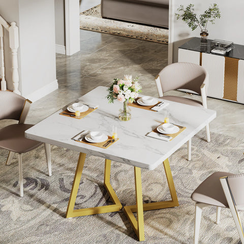 White marble dining table with gold legs and cream chairs
