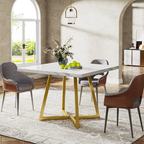 White marble dining table with gold crossed legs and grey chairs