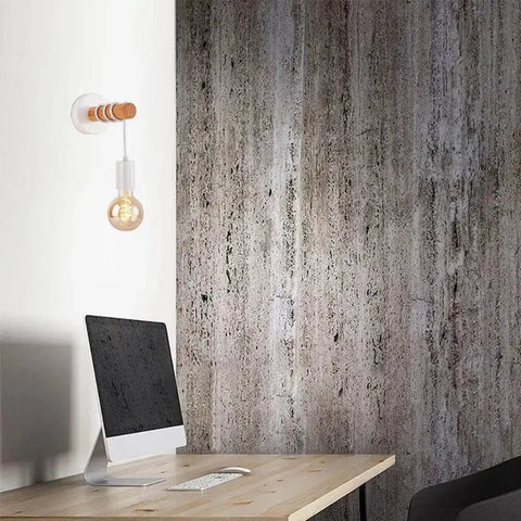 Wooden bead wall sconce on a concrete wall above a desk