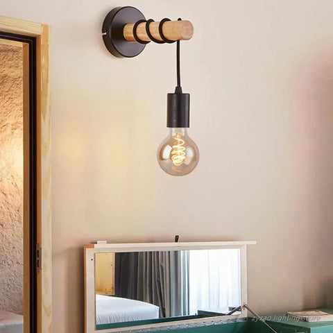 Wooden bead wall sconce lit with a filament bulb