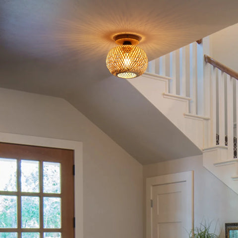 Woven bamboo ceiling lamp in a hallway beside a staircase