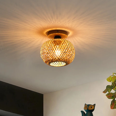 Woven bamboo ceiling lamp lit on a white ceiling