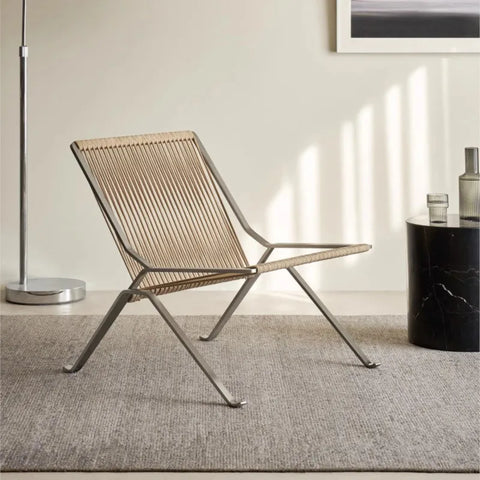 Woven cord lounge chair with a steel frame in a bright room