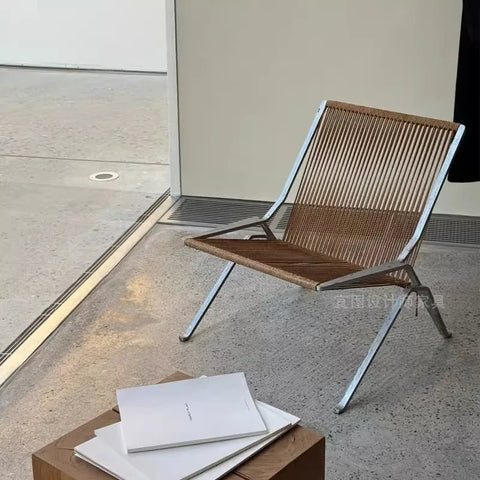 Woven cord lounge chair beside a low table