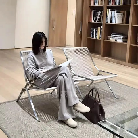 Someone reading in the woven cord lounge chair