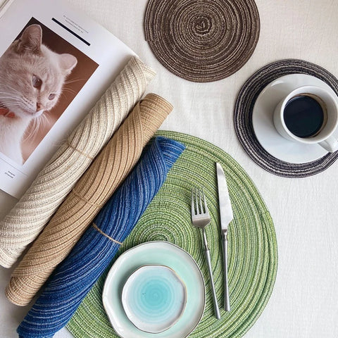 Blue and green woven placemats with a bowl and cutlery