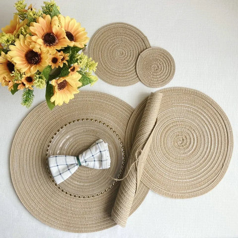Cream woven placemats with a folded napkin and sunflowers