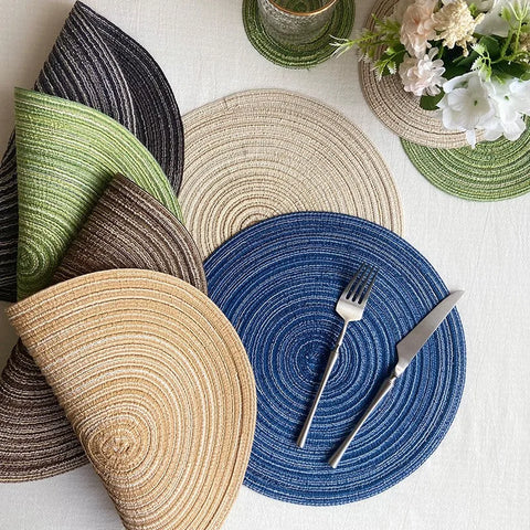 Yarn woven round placemats in several colours on a laid table