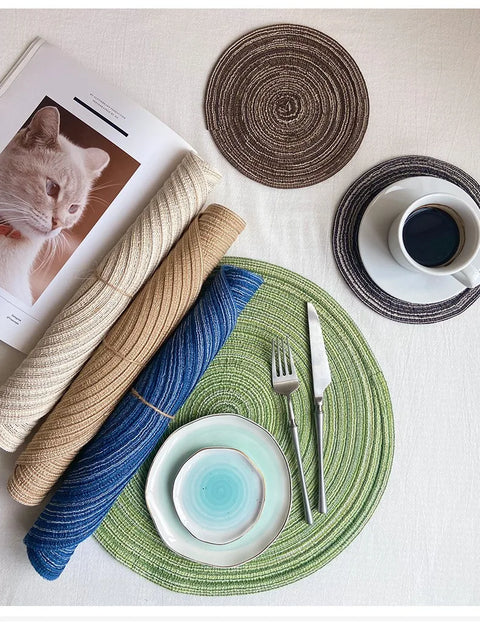 Layered blue and green woven placemats at a place setting