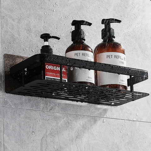 Single black bathroom shelf holding pump bottles