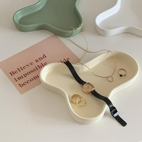 Cloud accessory tray in beige, shown alongside the green and white colourways
