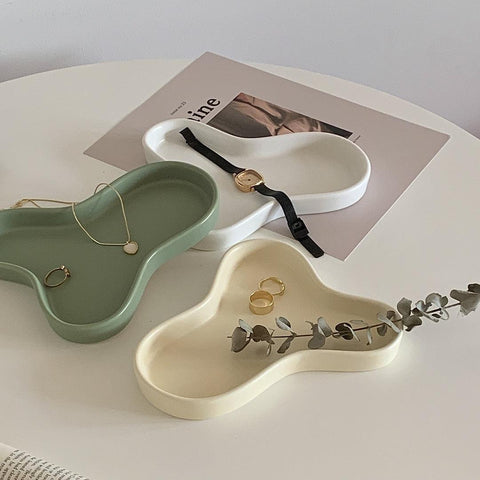 Green and beige Cloud accessory trays holding a watch, rings and a necklace