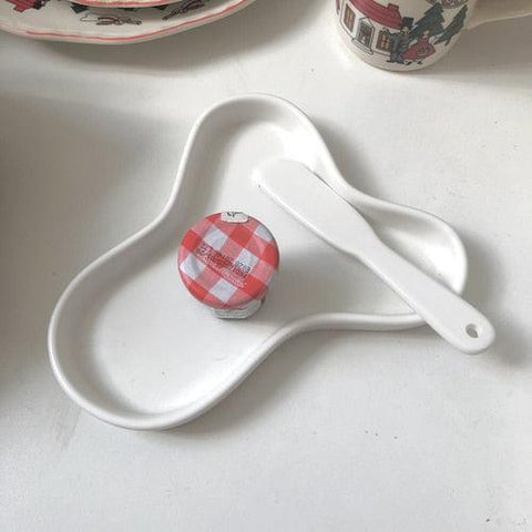 Cloud accessory tray in white, cloud-shaped ceramic dish on a pale surface