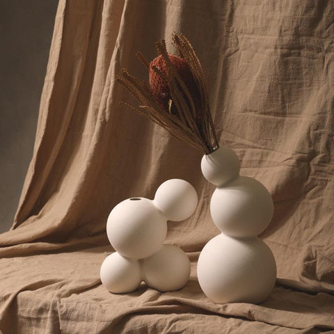 Droplet ceramic vases holding dried stems