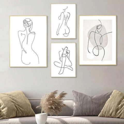 Five female line-drawing prints arranged as a gallery wall above a linen sofa