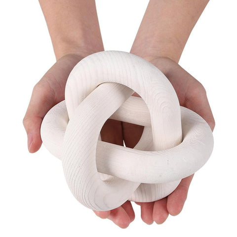 White knotted chain sculpture held in two hands