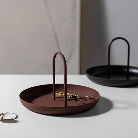 Red clay and black Loop accessory trays holding rings and earrings