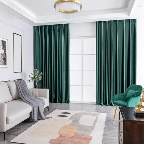 Dark green velvet curtains in a bright living room