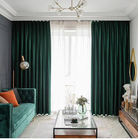 Dark green velvet curtains framing a window in a living room