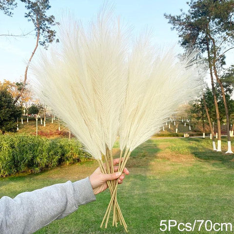 Bunch of lemon-toned pampas grass held up outdoors