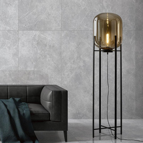Nordic Glow floor lamp in cognac glass beside a grey sofa