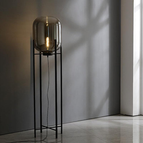 Tall Nordic Glow floor lamp lit in the corner of a room