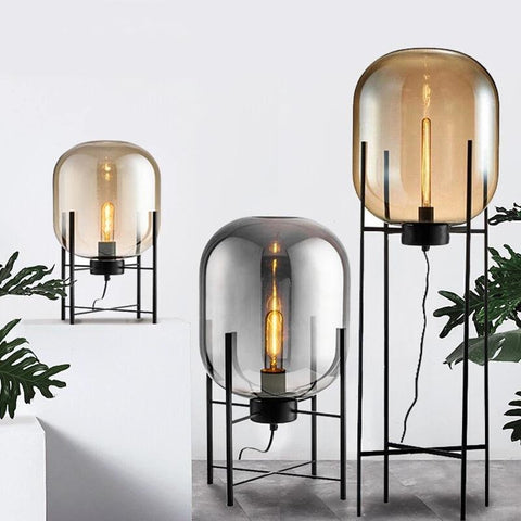 Three Nordic Glow floor lamps in different heights and glass tints