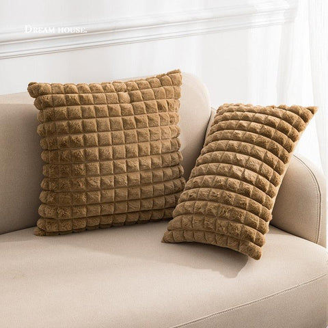Raised square cushion covers in coffee brown on a sofa