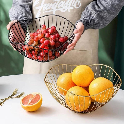 Black wire fruit basket being lifted, holding cherry tomatoes