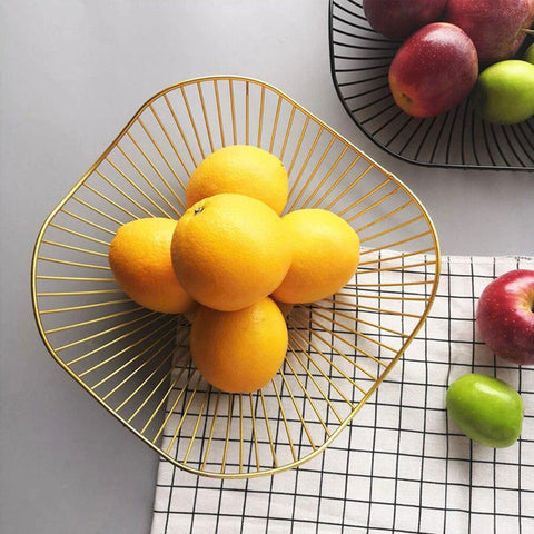 Gold wire fruit basket holding lemons and apples