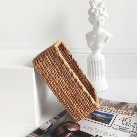 Rattan storage basket on a shelf beside a sculpture