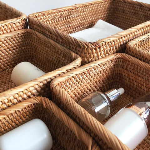Rattan storage baskets holding bottles and toiletries
