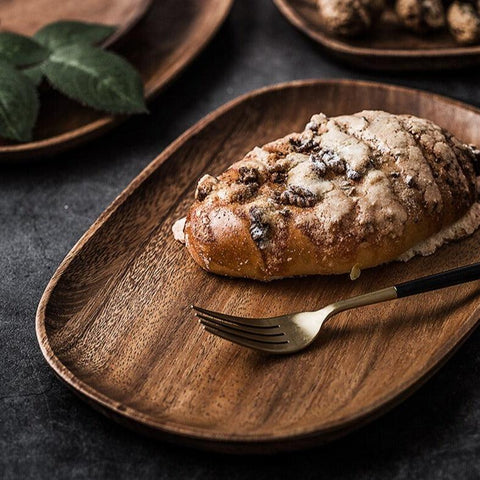 Wooden plate holding a slice of cake